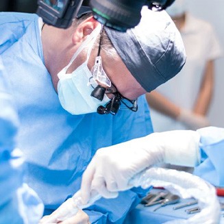 Dental team performing dental implant surgery