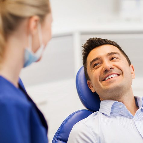 Man smiles at dentist