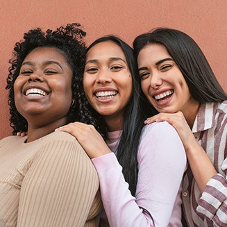 Group of friends smiling together outside