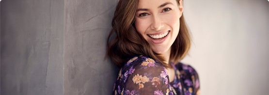 Woman in flowery blouse smiling